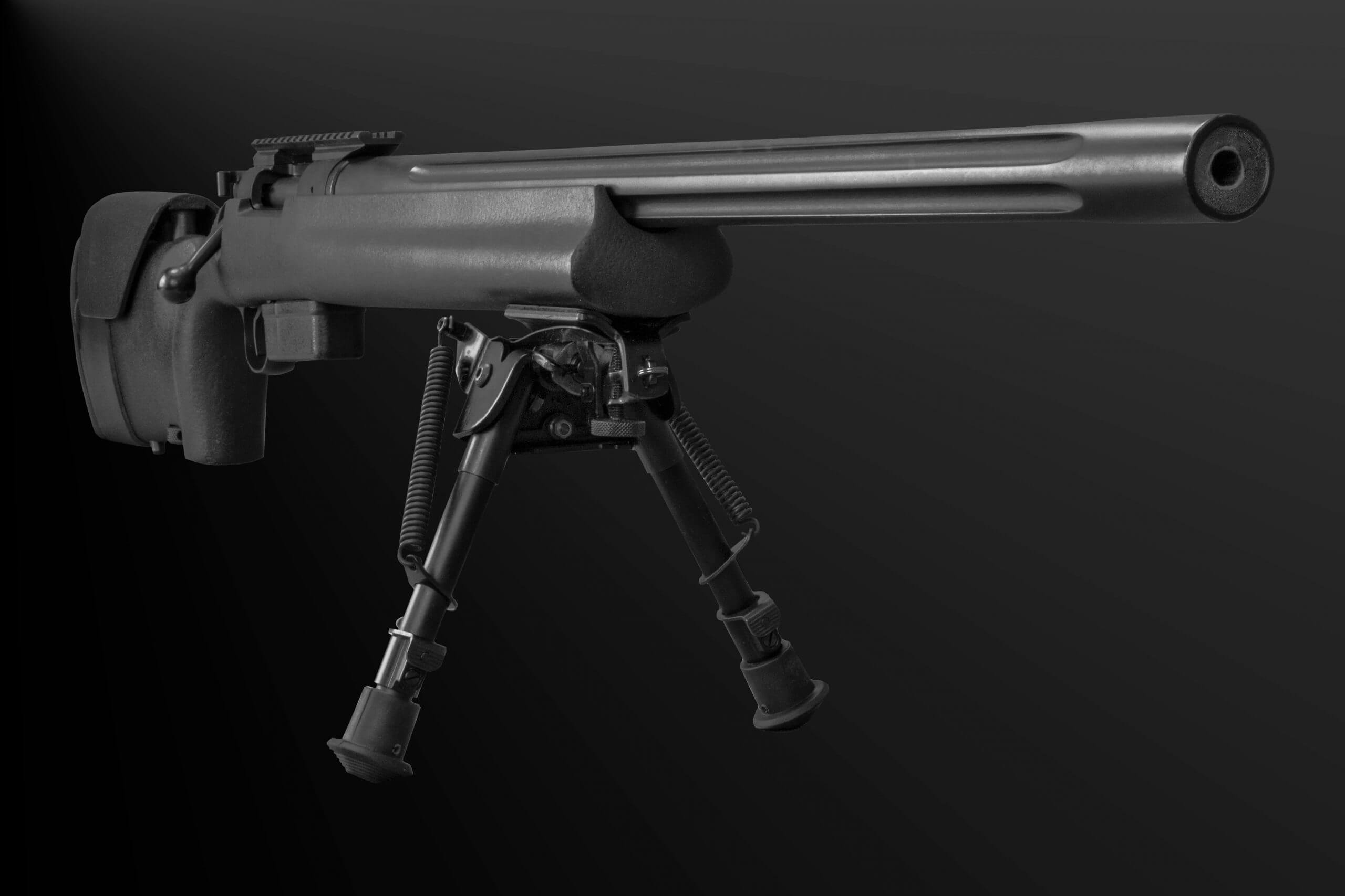 Bolt Action Rifle With Bipod On Black Background