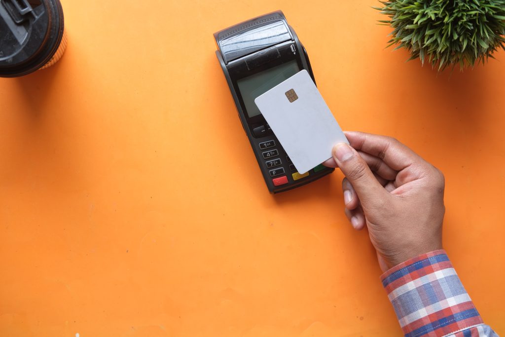 man using credit card processing machine