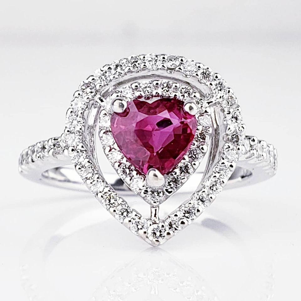 Diamond engagement ring with heart shaped emerald