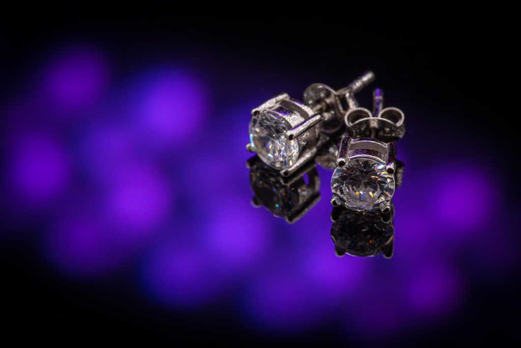 Beautiful silver earrings with crystal on clipping path background